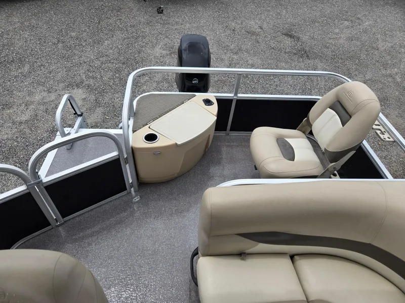 Slide: The Image of 2016 Sun Tracker Bass Buggy 18 DLX pontoon boat interior with beige seating and console. - 12