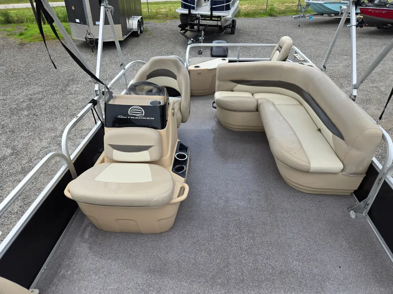 Slide: The Image of 2016 Sun Tracker Bass Buggy 18 DLX pontoon boat with beige seating and spacious deck. - 13