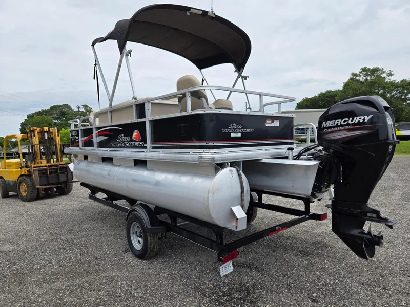 Slide: The Image of 2016 Sun Tracker Bass Buggy 18 DLX pontoon boat with Mercury outboard motor on trailer. - 6