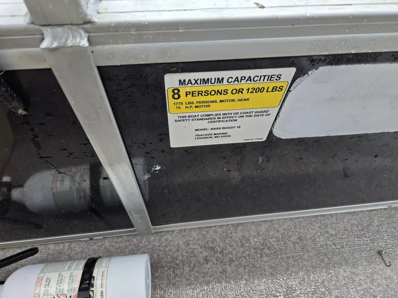 Slide: The Image of 2016 Sun Tracker Bass Buggy 18 DLX capacity label, 8 persons or 1200 lbs limit. - 7