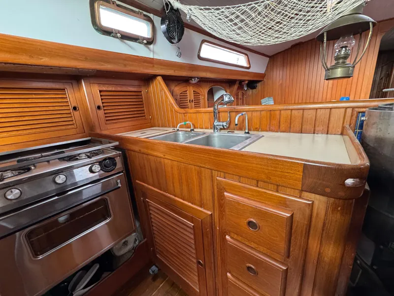 Slide: The Image of Wooden galley kitchen in 1982 Passport 40 sailboat with stove and sink. - 22