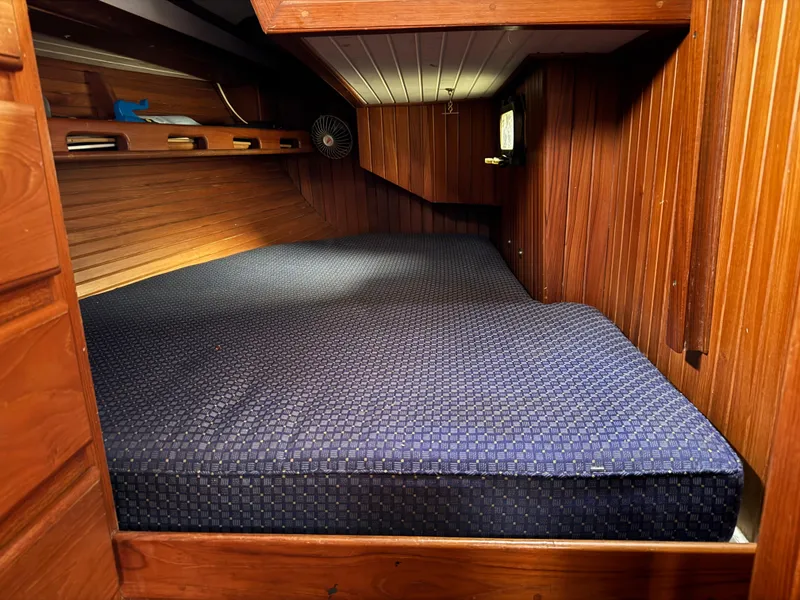 Slide: The Image of Cozy wooden cabin interior with blue mattress, Passport 40 sailboat, 1982 model. - 31