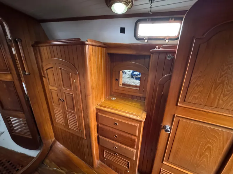 Slide: The Image of Interior of 1982 Passport 40 sailboat with wooden cabinetry and drawers. - 34
