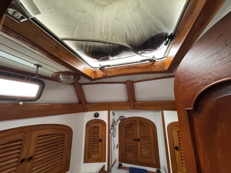 Slide: The Image of Interior of 1982 Passport 40 sailboat with wooden cabinetry and skylight. - 36