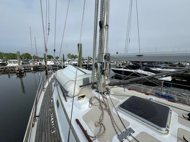 Slide: The Image of Sailboat docked at marina, Passport 40 model, 1982, with visible deck and rigging. - 4