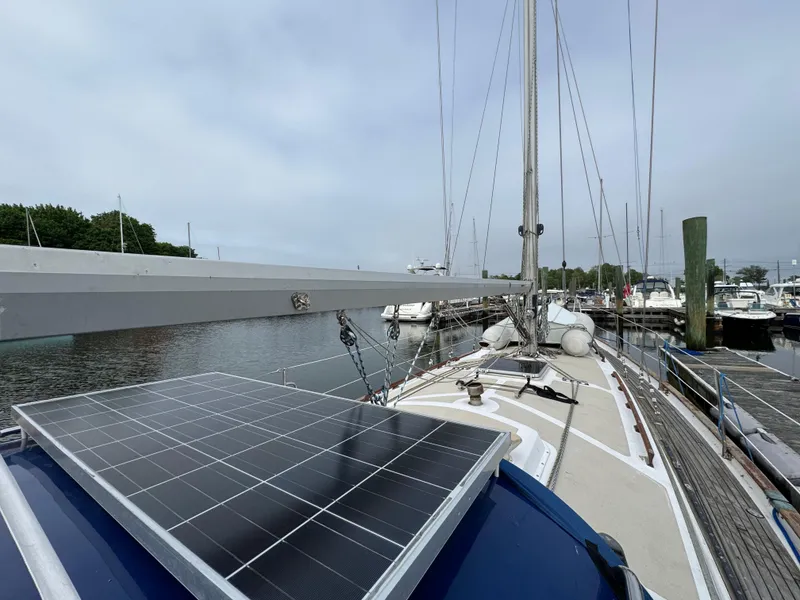 Slide: The Image of Sailboat with solar panel docked at marina, Passport 40 model, 1982. - 5