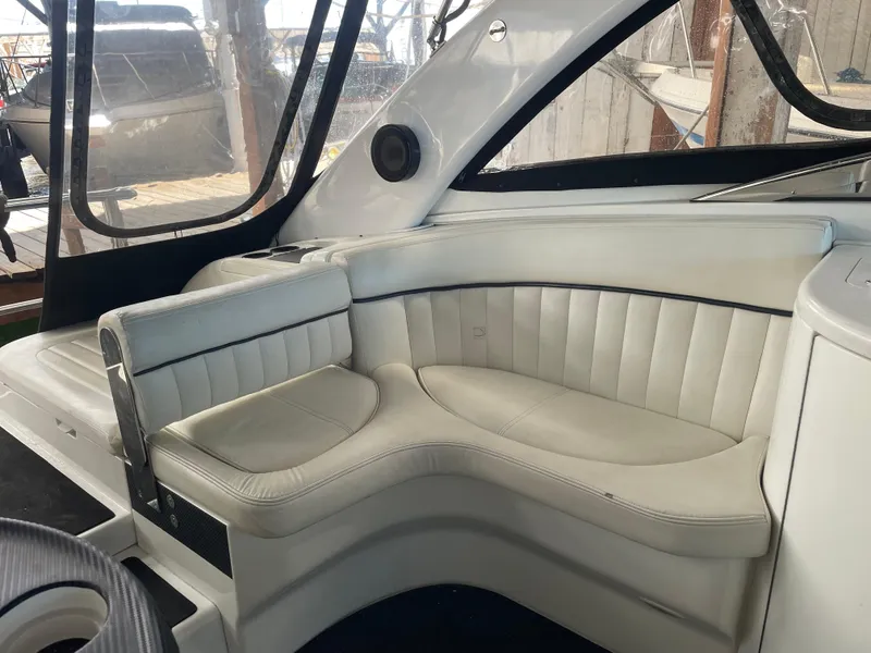 Slide: The Image of 2004 Cobalt 360 boat interior with white leather seating and panoramic windows. - 10