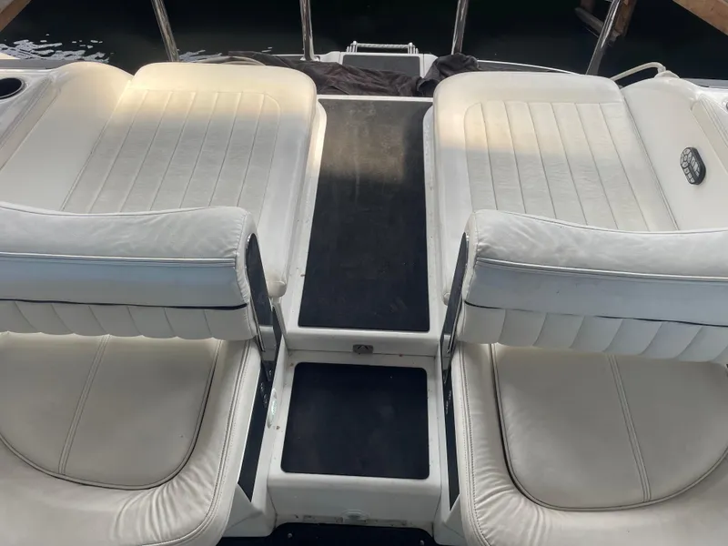 Slide: The Image of White leather seating on a 2004 Cobalt 360 boat deck. - 12