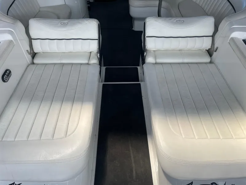 Slide: The Image of 2004 Cobalt 360 boat interior with white leather seating and black carpet. - 14