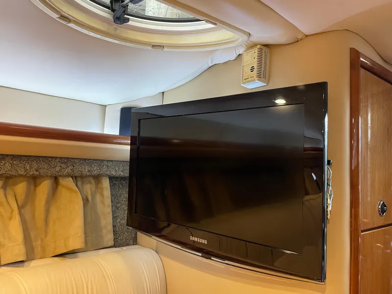 Slide: The Image of Flat-screen TV inside a 2004 Cobalt 360 boat cabin, near a porthole window. - 17