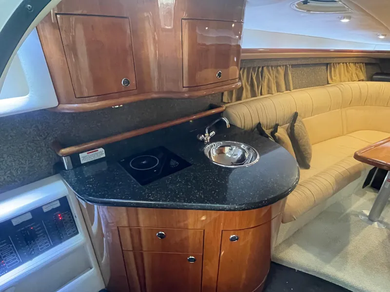 Slide: The Image of Luxurious 2004 Cobalt 360 yacht interior with kitchenette and plush seating. - 18