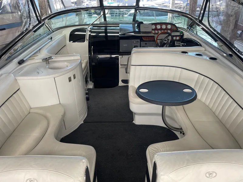 Slide: The Image of Luxurious interior of a 2004 Cobalt 360 boat with white seating and a compact table. - 2