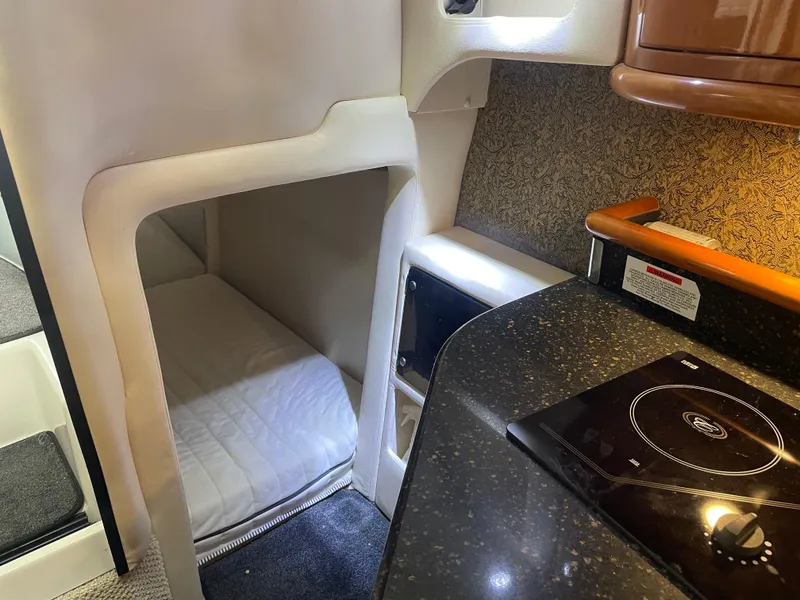 Slide: The Image of Interior of 2004 Cobalt 360 boat with compact bed and kitchenette. - 21