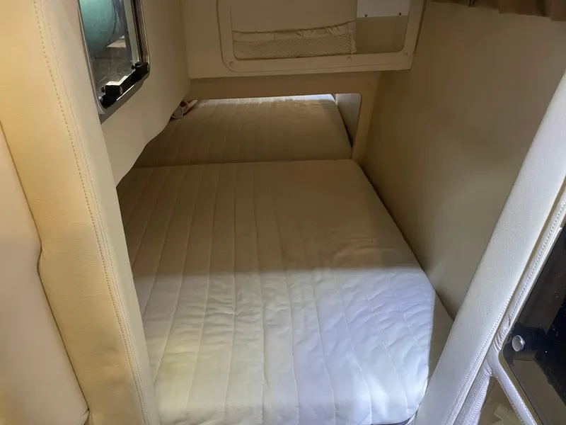 Slide: The Image of Interior cabin of a 2004 Cobalt 360 boat with a cozy bed setup. - 22
