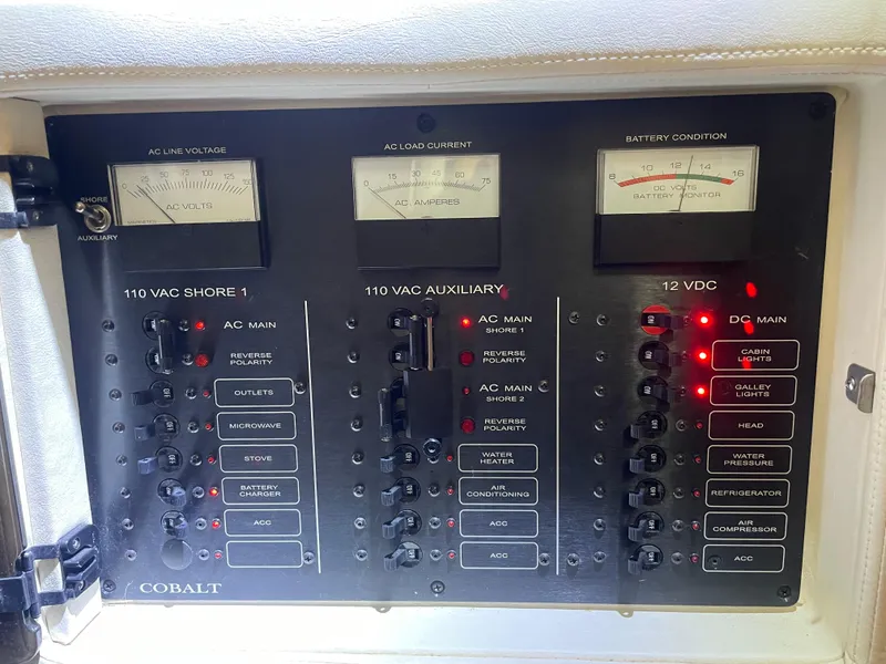 Slide: The Image of Electrical control panel of a 2004 Cobalt 360 boat with voltage and current meters. - 25