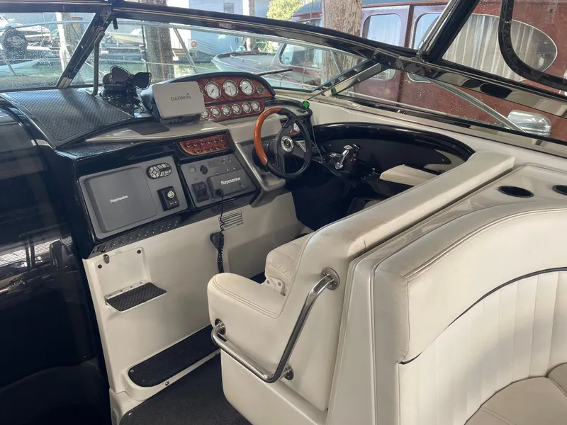 Slide: The Image of Interior of a 2004 Cobalt 360 boat with steering wheel and navigation equipment. - 3