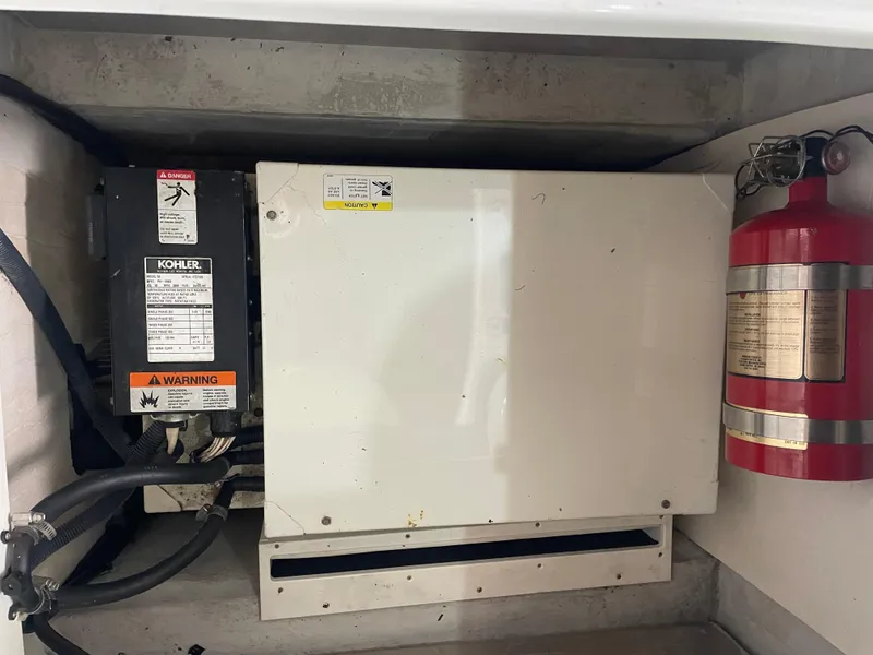 Slide: The Image of Engine compartment of a 2004 Cobalt 360 with a Kohler generator and fire extinguisher. - 31