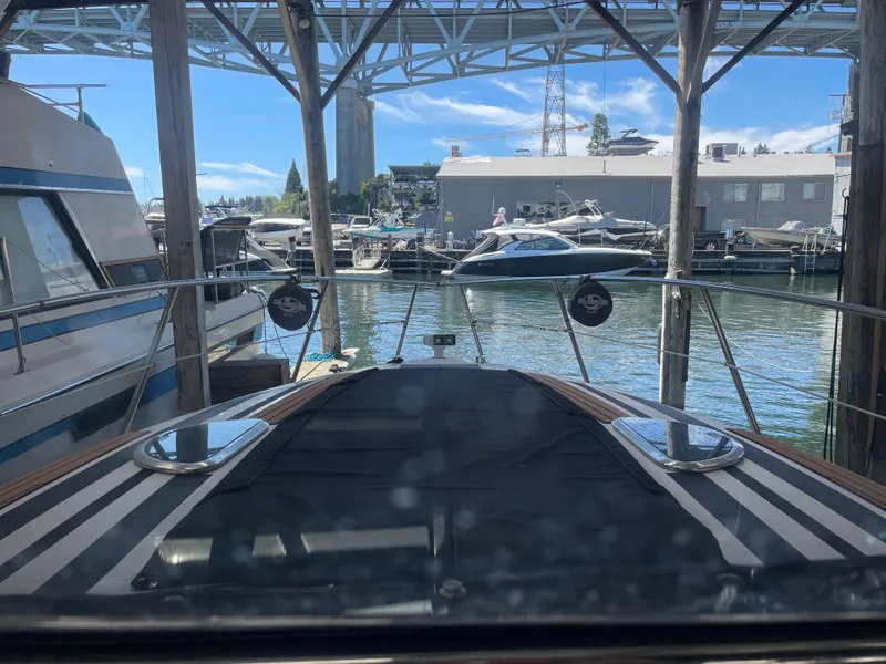 Slide: The Image of Cobalt 360 boat docked in a marina, surrounded by other vessels, under a clear blue sky. - 33