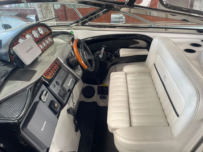 Slide: The Image of Interior of a 2004 Cobalt 360 boat with white seating and advanced navigation equipment. - 4