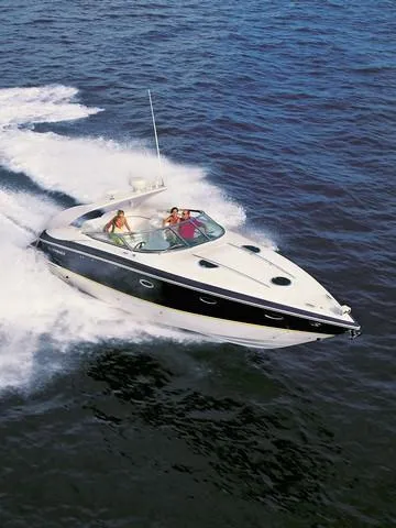 Slide: The Image of 2004 Cobalt 360 boat cruising on open water with passengers onboard. - 40