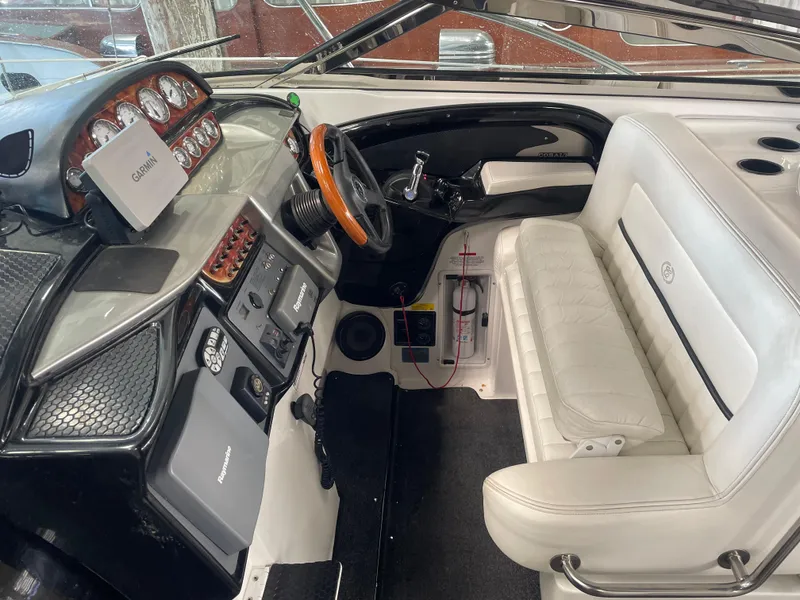 Slide: The Image of Interior of a 2004 Cobalt 360 boat with white seating and navigation equipment. - 5