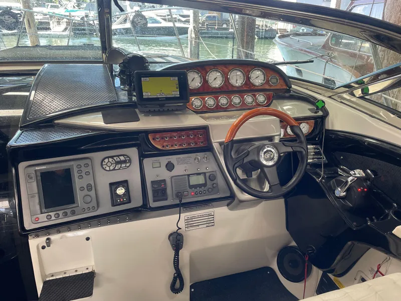 Slide: The Image of Cockpit of a 2004 Cobalt 360 boat with steering wheel and navigation instruments. - 6