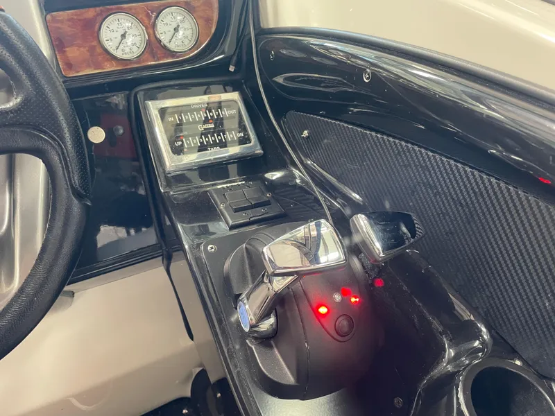 Slide: The Image of 2004 Cobalt 360 boat dashboard with controls and gauges, featuring a sleek black design. - 9