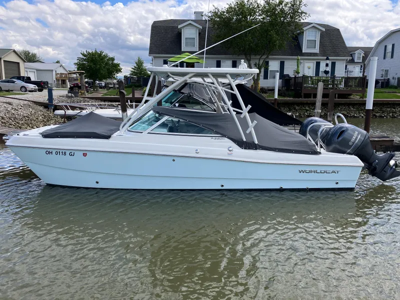 Slide: The Image of 2022 World Cat 230 SD boat docked in a residential canal setting. - 10