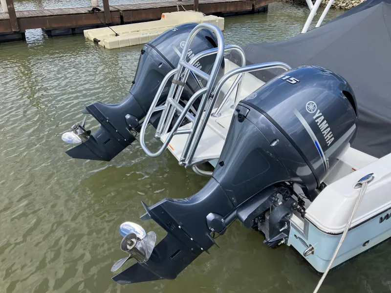 Slide: The Image of 2022 World Cat 230 SD with dual Yamaha outboard motors docked in water. - 15