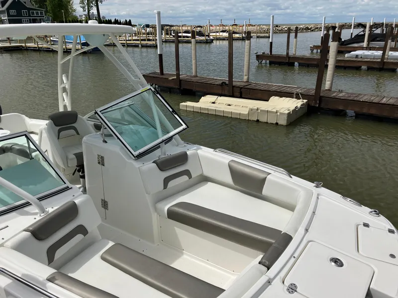 Slide: The Image of 2022 World Cat 230 SD boat docked at marina, featuring spacious seating and modern design. - 16