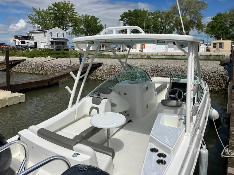 Slide: The Image of 2022 World Cat 230 SD boat docked, featuring spacious seating and modern design. - 20