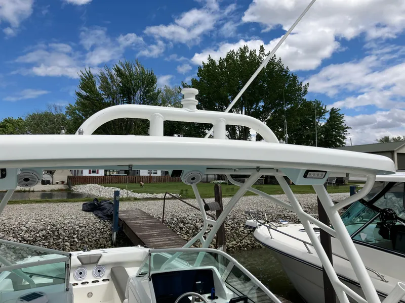Slide: The Image of 2022 World Cat 230 SD boat docked, featuring a sleek white design under a blue sky. - 22