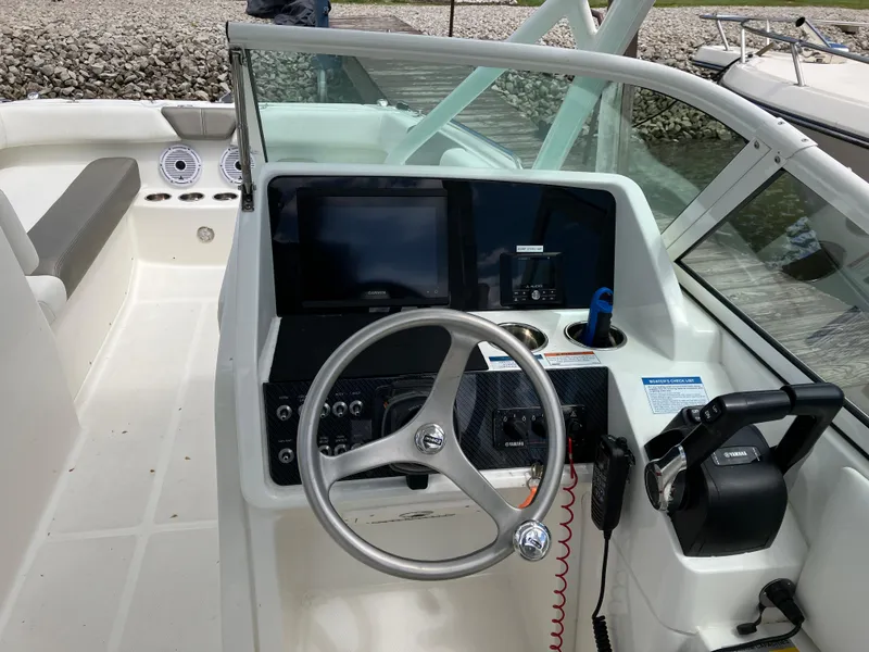 Slide: The Image of 2022 World Cat 230 SD boat helm with steering wheel and control panel. - 24