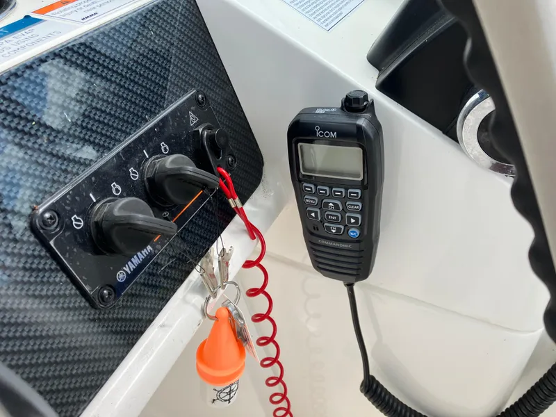 Slide: The Image of Control panel and radio on a 2022 World Cat 230 SD boat. - 28