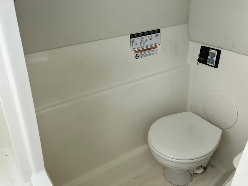 Slide: The Image of 2022 World Cat 230 SD boat interior with compact marine toilet. - 30