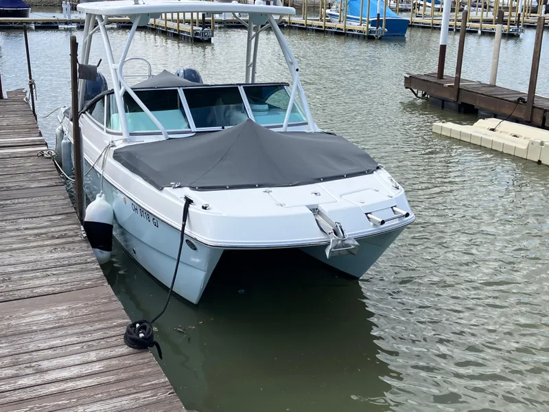 Slide: The Image of 2022 World Cat 230 SD boat docked in marina, covered and secured. - 4