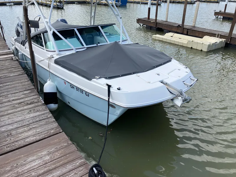 Slide: The Image of 2022 World Cat 230 SD boat docked at marina with cover. - 5