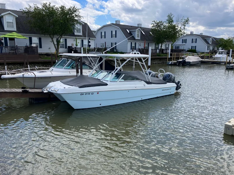 Slide: The Image of 2022 World Cat 230 SD boat docked in a residential canal setting. - 7