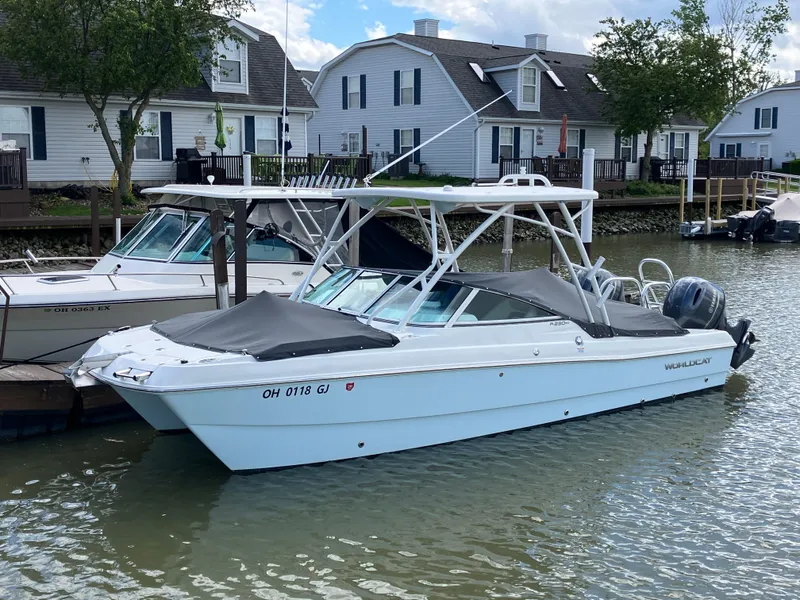 Slide: The Image of 2022 World Cat 230 SD boat docked in a residential marina. - 9