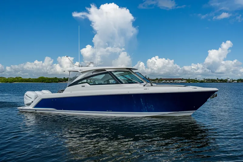 Slide: The Image of 2021 Tiara Yachts 38 LX cruising on a sunny day with blue skies. - 0