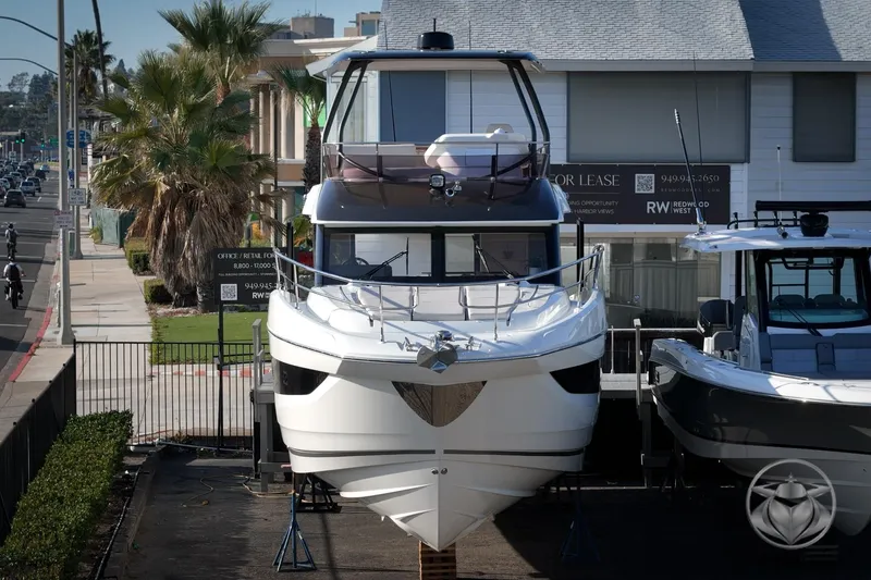 Slide: The Image of 2026 Prestige F4.3 yacht displayed outdoors, urban background, palm trees, and street view. - 10