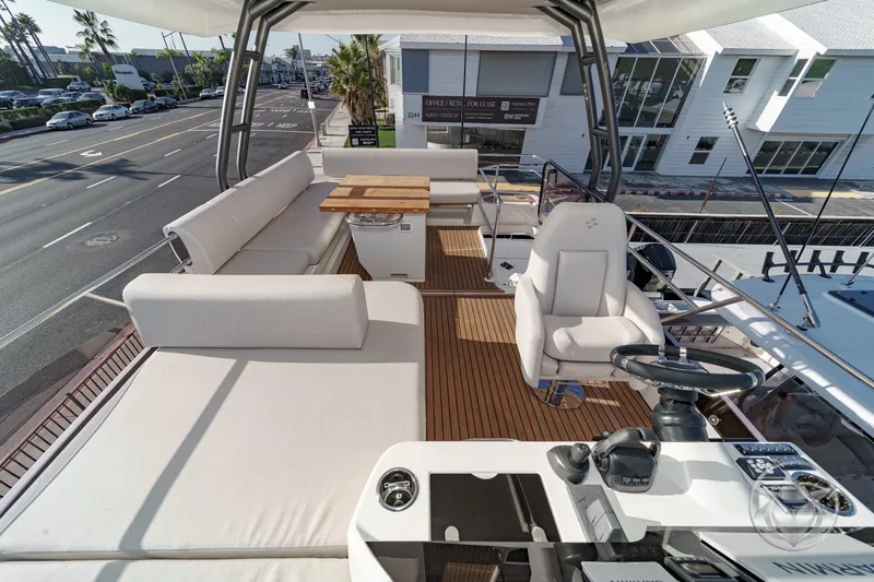 Slide: The Image of Luxurious 2026 Prestige F4.3 yacht deck with seating, steering, and wooden flooring. - 14
