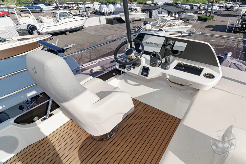Slide: The Image of Prestige F4.3 yacht helm with Garmin navigation, 2026 model, featuring luxurious seating and controls. - 16