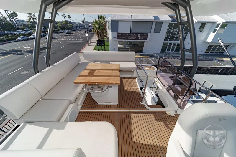 Slide: The Image of Luxurious 2026 Prestige F4.3 yacht deck with elegant seating and wooden table. - 17