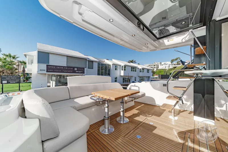 Slide: The Image of Luxurious 2026 Prestige F4.3 yacht deck with elegant seating and wooden flooring. - 21