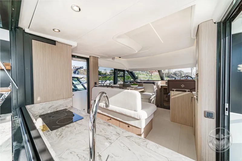 Slide: The Image of Luxurious interior of 2026 Prestige F4.3 yacht with modern kitchen and seating area. - 23