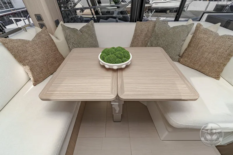 Slide: The Image of Cozy yacht interior with a wooden table, decorative pillows, and a bowl of greenery. Prestige F4.3 2026. - 30
