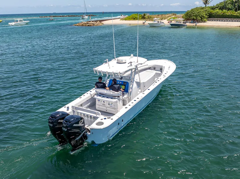 Slide: The Image of A 2011 Revenge 35LT boat cruising near a tropical island with clear blue waters. - 10