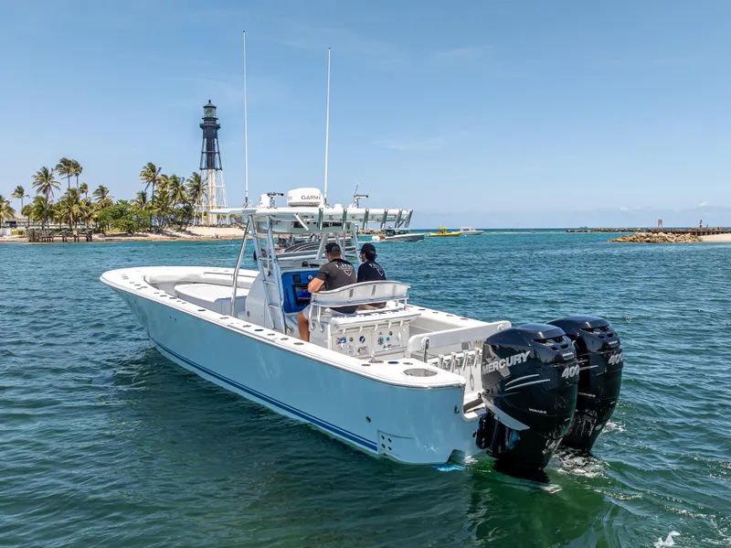 Slide: The Image of 2011 Revenge 35LT boat cruising near a lighthouse on a sunny day. - 11