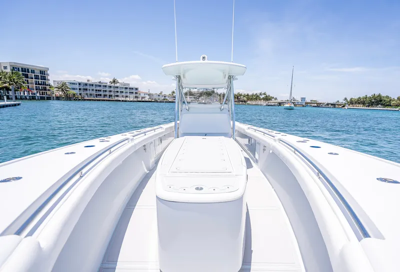 Slide: The Image of 2011 Revenge 35LT boat on clear blue water with coastal buildings in the background. - 12
